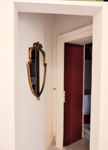 a mirror hanging on a wall next to a door at Morosoli Spa in Catania