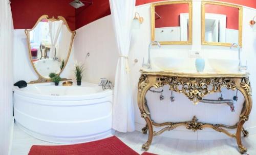 a bathroom with a tub and a sink and a mirror at Morosoli Spa in Catania