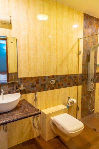 a bathroom with a toilet and a sink and a shower at Calangute Candolim Beach Bay villas and Apartments in Baga