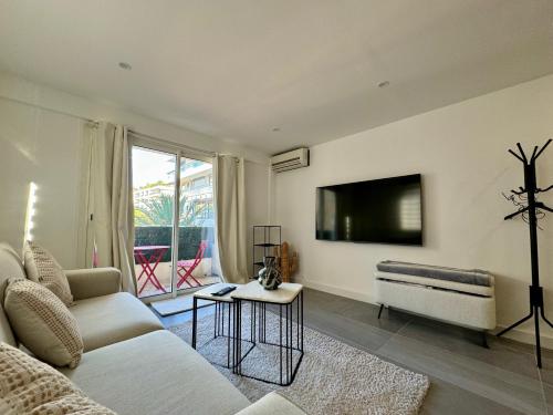 un salon avec un canapé et une télévision à écran plat dans l'établissement Studio de 30m2 - À 5min du centre, à Cannes