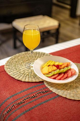 a plate of vegetables and a glass of orange juice at Best Western Plus Posada de Don Vasco in Pátzcuaro