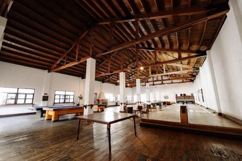 a large room with tables and ping pong tables at Best Western Plus Posada de Don Vasco in Pátzcuaro