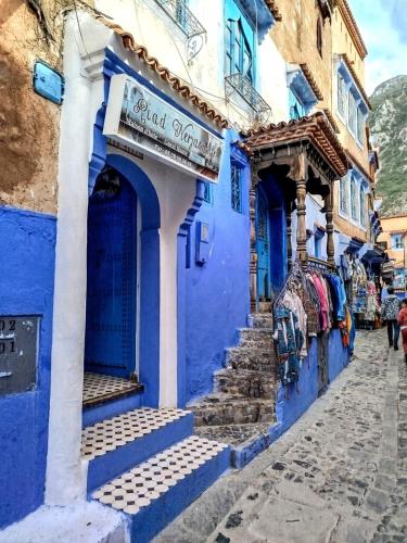 a blue building with a sign on it at Riad Nerja in Chefchaouene