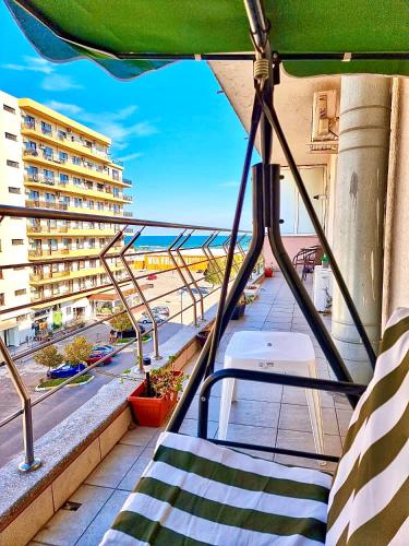 a balcony with a view of a beach and buildings at Summerland Seaview Apartments in Mamaia