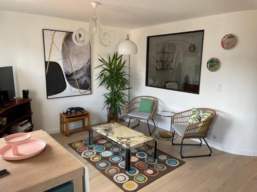 a living room with two chairs and a table at T2bis St Charles in Biarritz