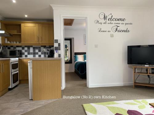 a kitchen with a door open to a living room at Woodpaddock Bed & Breakfast in March