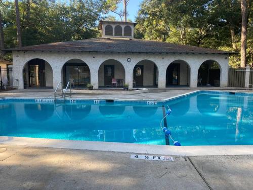 a swimming pool in front of a building at #111 Elaborate Condo Ideal Location 2BRM/2 Parking in Hilton Head Island