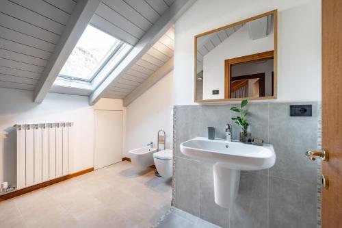 a bathroom with a sink and a toilet at Villa Golden Lake 2 - just few steps from the lake in Dervio