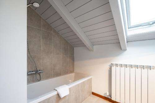 a bathroom with a bath tub and a window at Villa Golden Lake 2 - just few steps from the lake in Dervio