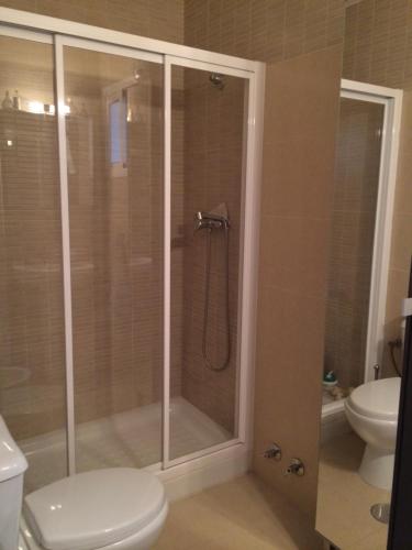 a bathroom with a shower and a toilet at URBION HOME in Seville