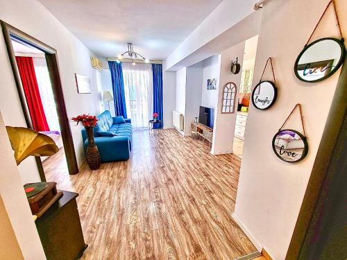 a living room with a blue couch and a room with at Summerland Seaview Apartments in Mamaia