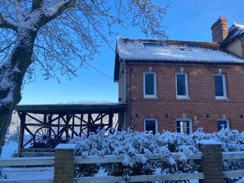 a house with a pile of snow in front of it at Maison La folie douce in Saint-Pierre-de-Manneville