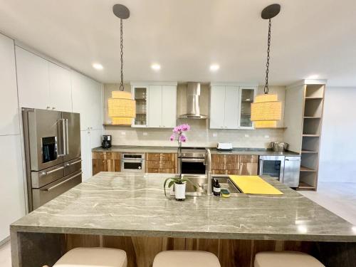a large kitchen with a large marble counter top at Esterillos Lote home in Esterillos
