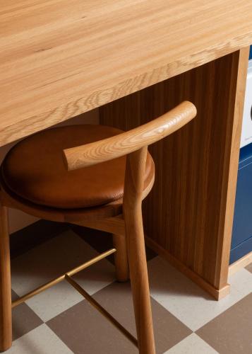a wooden desk with a wooden chair underneath it at ARRIVE Albuquerque in Albuquerque