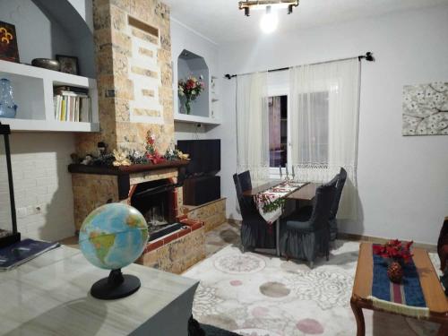 a living room with a fireplace and a table at Kostis Hause in Kastrákion