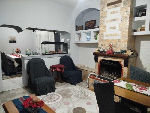 a living room with two chairs and a fireplace at Kostis Hause in Kastrákion