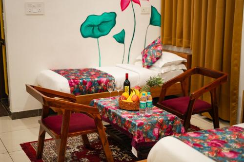 a room with two beds and a table with a bottle of wine at PETAL OF MEWAR - A Luxury Boutique Hotel in Udaipur