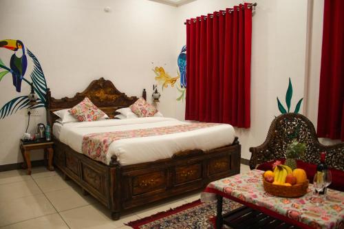 a bedroom with a bed and a red curtain at PETAL OF MEWAR - A Luxury Boutique Hotel in Udaipur