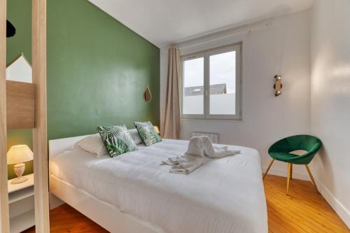 une chambre avec un lit blanc et un mur vert dans l'établissement Saint Maur F2 beau logement entier, à Rouen