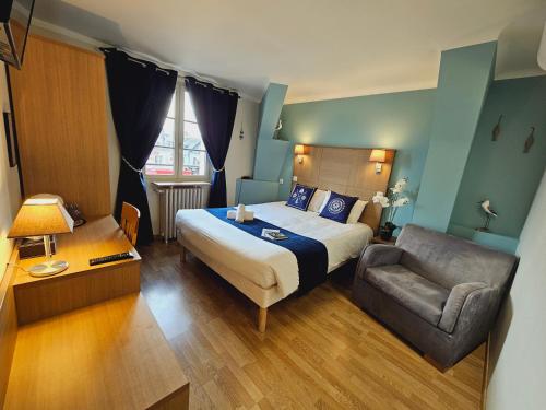 a hotel room with a bed and a chair at Logis Loire Hotel - Les Cocottes Restaurant in Les Rosiers-sur-Loire