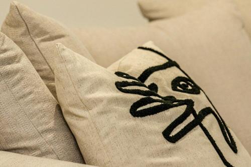 a pillow with a drawing of a woman on it at Wyndford Riverside House in Glasgow