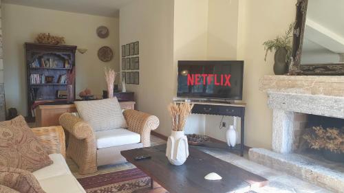 a living room with a tv and a fireplace at Private Villa with Panoramic View in Ayía Evthimía