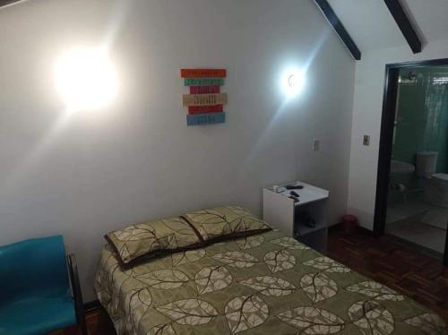 Postel nebo postele na pokoji v ubytování Hotel chimenea calle 100