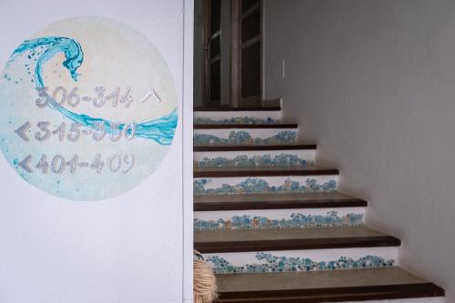 a painting of a wave on the stairs at Hotel Corallaro in Santa Teresa Gallura