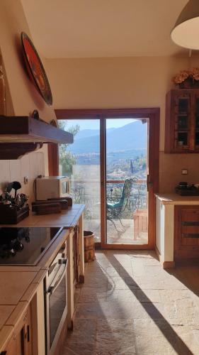 a kitchen with a large glass door with a view at Private Villa with Panoramic View in Ayía Evthimía
