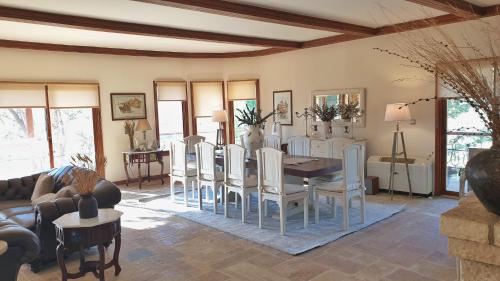 a living room with a dining room table and chairs at Private Villa with Panoramic View in Ayía Evthimía