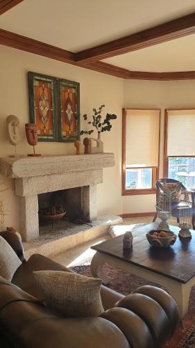 a living room with a couch and a fireplace at Private Villa with Panoramic View in Ayía Evthimía