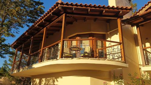 a balcony on the side of a building at Private Villa with Panoramic View in Ayía Evthimía