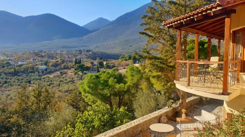 a house with a balcony with a view of mountains at Private Villa with Panoramic View in Ayía Evthimía