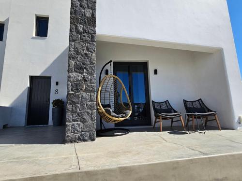 a couple of chairs sitting on a patio at myLithos Suites in Monolithos