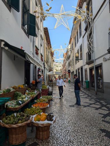 a street with a market with fruits and vegetables at Art House Funchalet in Funchal