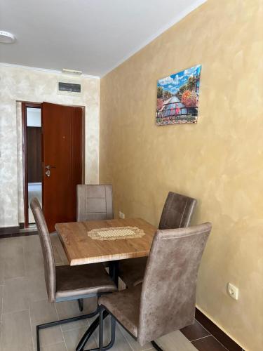 a dining room with a wooden table and chairs at Dale apartment Becici- Paradiso in Budva