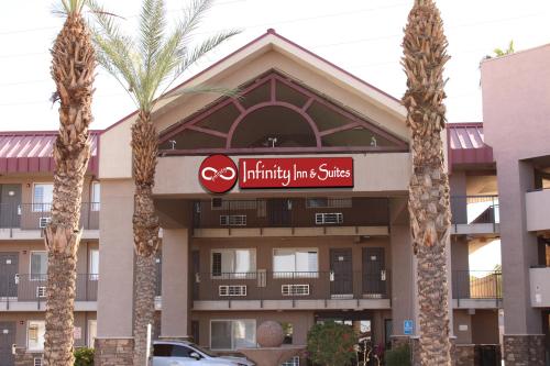 a building with palm trees in front of it at Infinity Inn & Suites in Tempe