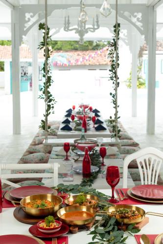 a long table with plates of food on it at Villa Havana Hues Private Villa in Bentota