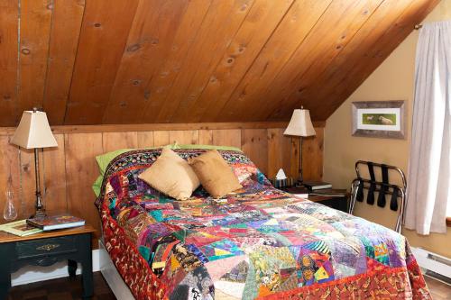 a bedroom with a bed with a wooden ceiling at Rustic Farmhouse in Gaspereau Valley Wine Country! in Wolfville
