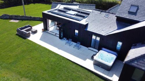 an aerial view of a house with a hot tub at Alynfa Barn House Rhosniegr in Rhosneigr