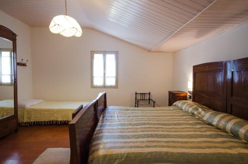 A bed or beds in a room at La Vallata appartamento in collina