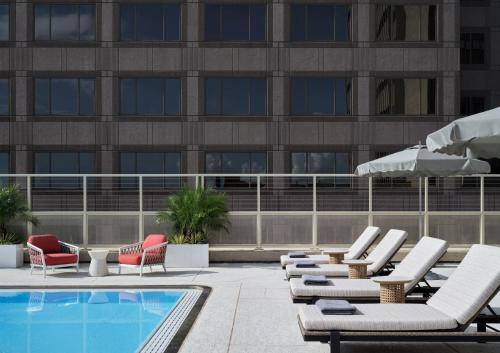 a swimming pool with lounge chairs and a building at InterContinental San Antonio Riverwalk by IHG in San Antonio