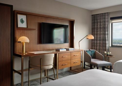 a hotel room with a desk and a television at InterContinental San Antonio Riverwalk by IHG in San Antonio