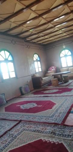 Habitación grande con alfombras grandes en el suelo en DAR AGLMOUZ -Ighir aghzzaf-, en Kalaat MGouna