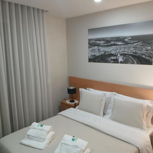 a hotel room with two beds with towels on them at CasAmalia 54 in Viana do Castelo