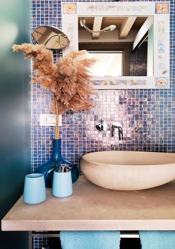 a bathroom counter with a sink and a mirror at La Casetta del Lago in Lovere