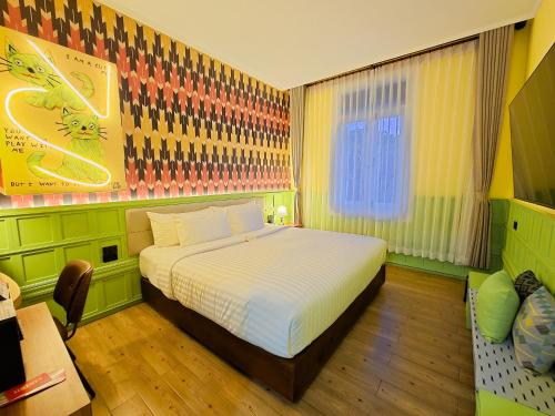 a bedroom with a white bed in a room at Senglao Boutique Hotel Luang Prabang in Luang Prabang