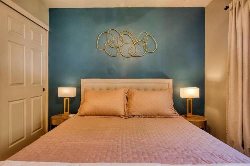 a bedroom with a large bed with two lamps at The Scott Casa - Walkable to Old Town Scottsdale, vibrant space, inviting patio! in Scottsdale