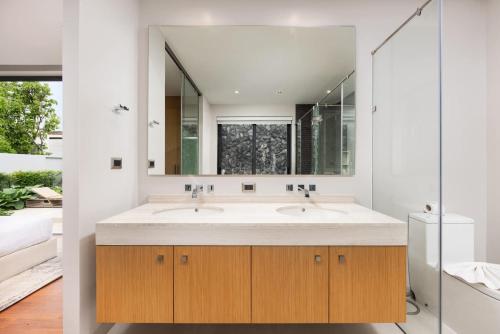 a bathroom with two sinks and a large mirror at Luxury 3BR Villa Eden with Private Pool by TropicLook in Ban Pak Lak