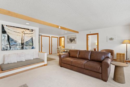 a living room with a couch and a table at Decatur 1785 by Summit County Mountain Retreats in Keystone